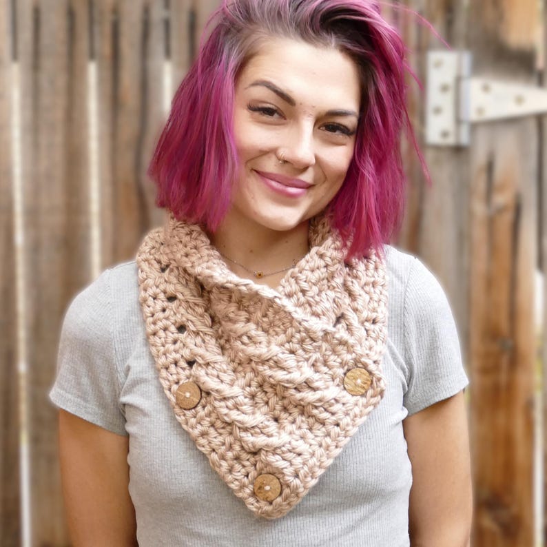 Elegant crochet cable button scarf made with super bulky yarn for warmth and rich texture. Features classic cable stitches and decorative buttons for a cozy, stylish finish. Shown in soft neutral tones, perfect for layering during fall and winter. Quick and easy PDF crochet pattern for beginners and advanced makers. A beautiful handmade cowl or neck warmer ideal for gifts, markets, or personal winter wear.