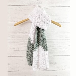 Chunky crochet chevron scarf featuring a modern ripple design made with the easy moss stitch. Crafted with bulky yarn for softness, warmth, and texture. Shown in coordinating neutral tones for a timeless handmade look. Beginner-friendly PDF crochet pattern that works up quickly and beautifully. Perfect winter accessory for gifting, markets, or cozy everyday wear with a touch of modern handmade style.