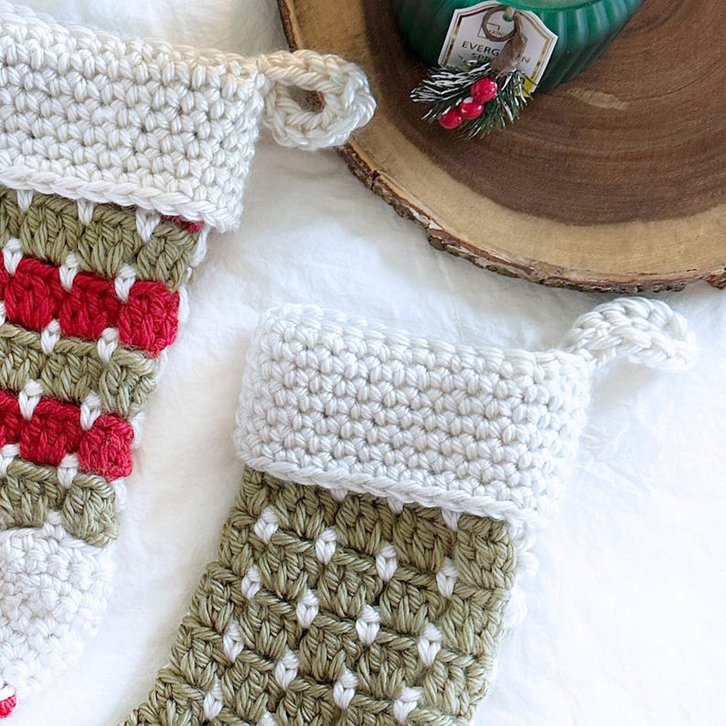 Chunky crochet Christmas stocking made with super bulky yarn for a cozy farmhouse holiday look. Features thick textured stitches and a wide hanging loop for easy display on mantels or stair rails. Shown in neutral tones for rustic, modern Christmas decor. Quick and easy PDF crochet pattern perfect for beginners and experienced makers. A timeless handmade stocking for festive home décor or thoughtful holiday gifting.