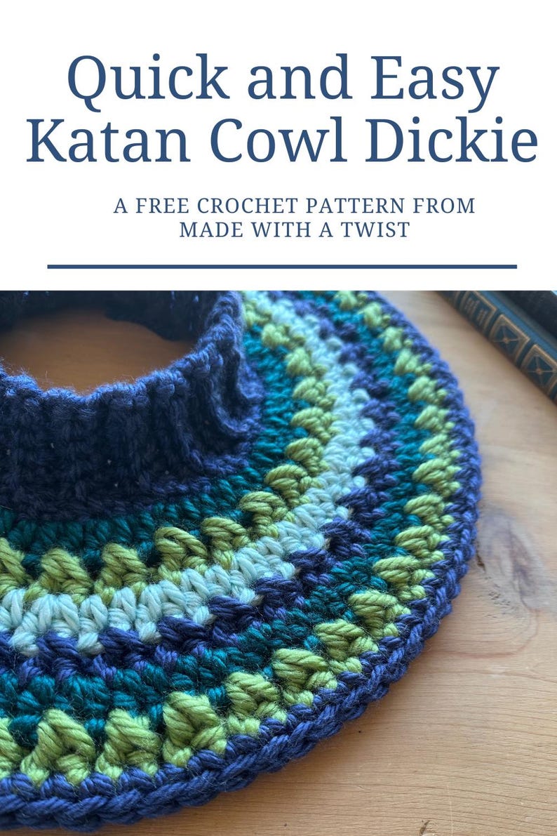 May include: A close-up of a blue, green, and white crocheted cowl neck. The cowl is made with a textured stitch and has a simple, elegant design. The text "Quick and Easy Katan Cowl Dickie" is displayed above the image. The text "A FREE CROCHET PATTERN FROM MADE WITH A TWIST" is displayed below the image.