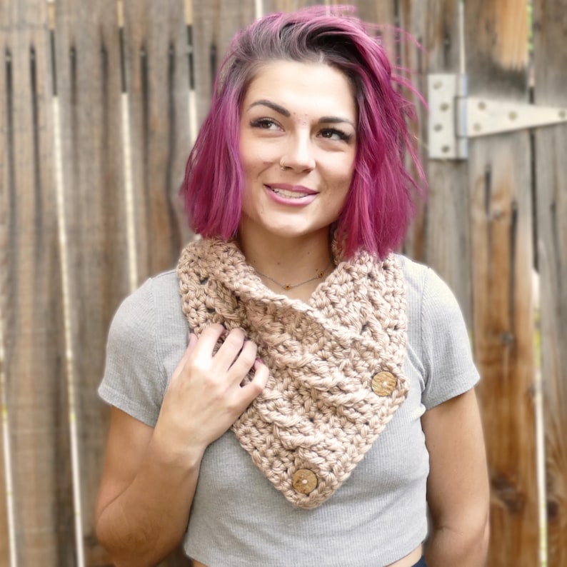 Elegant crochet cable button scarf made with super bulky yarn for warmth and rich texture. Features classic cable stitches and decorative buttons for a cozy, stylish finish. Shown in soft neutral tones, perfect for layering during fall and winter. Quick and easy PDF crochet pattern for beginners and advanced makers. A beautiful handmade cowl or neck warmer ideal for gifts, markets, or personal winter wear.