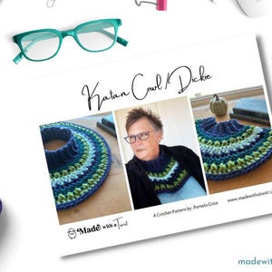 May include: A crochet pattern for a Katan cowl and dickey, featuring a blue, green, and white color scheme. The pattern is by Pamela Grace and is available on the website madewithatwist.com.