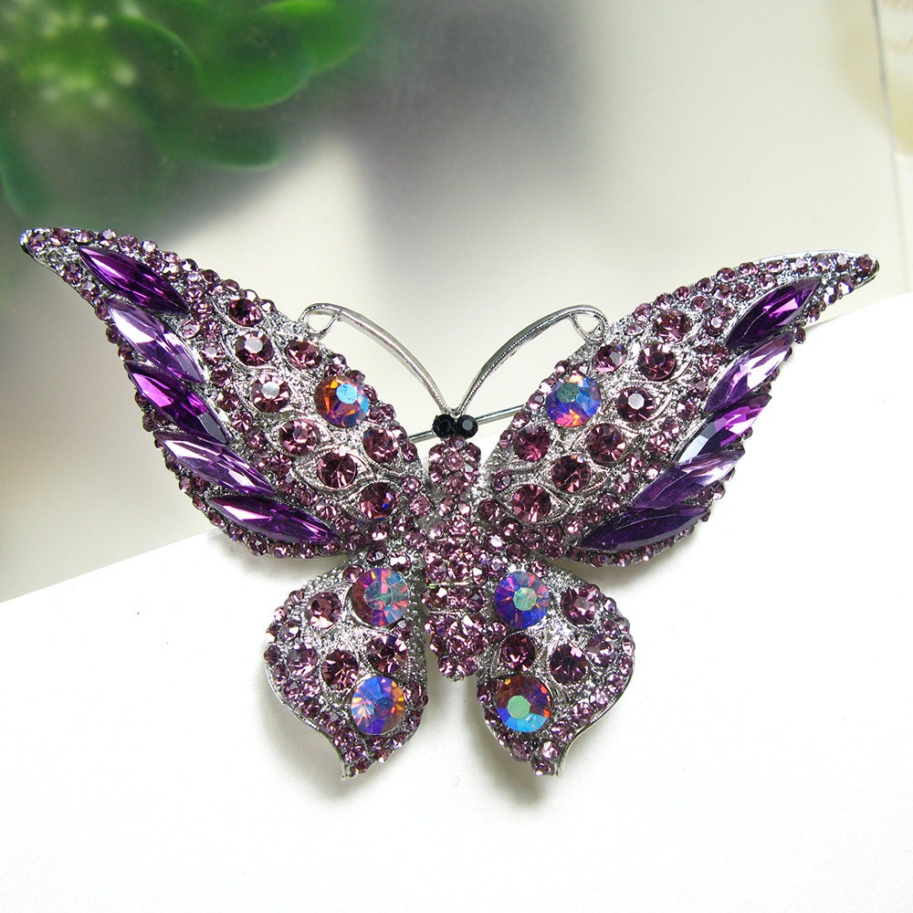 At Auction: Silver tone white faux pearl, clear and iridescent rhinestones,  purple enamel butterfly brooch