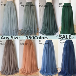 May include: A selection of tulle skirts in various colours, including sage, deep lotus green, dark green, forest green, khaki, pale ochre, dusty blue, and navy. The skirts are all full-length and have a high waist. The text "Any Size +150Colors" and "SALE" are visible in the image.