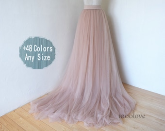 May include: A blush pink tulle skirt with a satin waistband. The skirt is long and flowing, and it would be perfect for a wedding or other special occasion.  +48 Colors Any Size