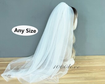 May include: White tulle wedding veil with a single layer and a scalloped edge. The veil is shown on a mannequin head. Any Size.