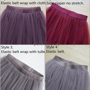 May include: Four different styles of tulle skirts. The first skirt is a purple tulle skirt with an elastic waistband. The second skirt is a burgundy tulle skirt with a side zipper. The third skirt is a gray tulle skirt with an elastic waistband. The fourth skirt is a gray tulle skirt with an elastic waistband.