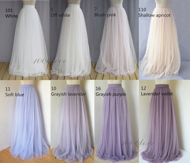 May include: A collage of ten tulle skirts in various colors, including white, off-white, blush pink, shallow apricot, soft blue, grayish lavender, grayish purple, and lavender violet. Each skirt has a waistband and is made of a soft, flowing fabric.