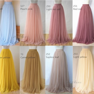 May include: A set of ten tulle skirts in various colors, including sky blue, peach pink, light rose, red soil, summer yellow, camel yellow, sapless leaf, and light yellow. The skirts are all full-length and have a gathered waist.