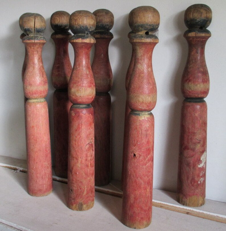 antique skittles game with wooden pins and iron bumbers