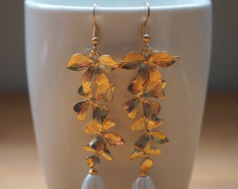 Long gold plated leaf and ceramic bead earrings