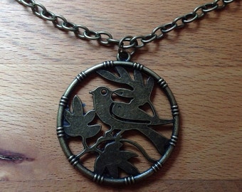 Framed bird on branch pendant on antique brass bronze necklace