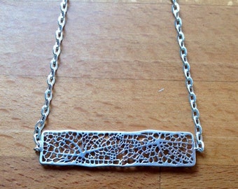 Long matte silver filigree mesh bar necklace.