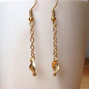 A PAIR OF CUTE LITTLE GOLD COLOUR LEAF DANGLY EARRINGS. NEW