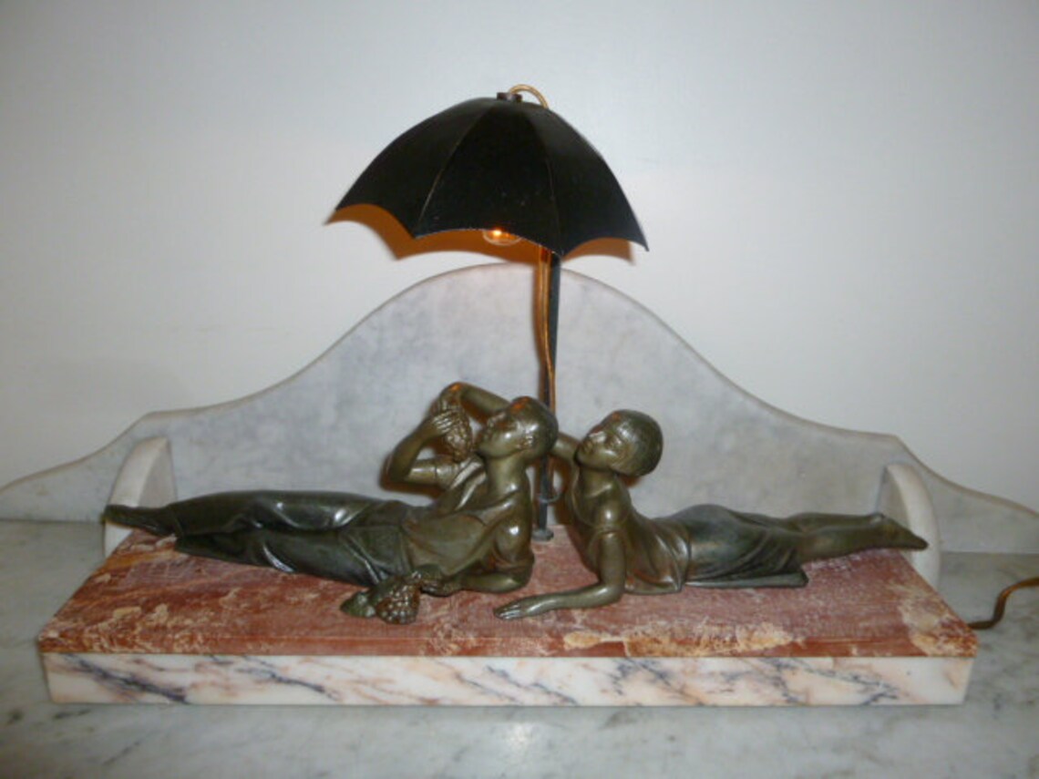 Rare French Art Deco spelter woman and man umbrella figural image 0