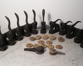 Old industrial lot of 11 cast iron Fabric Trading Company seals stamps brass discs accessories in case 1946