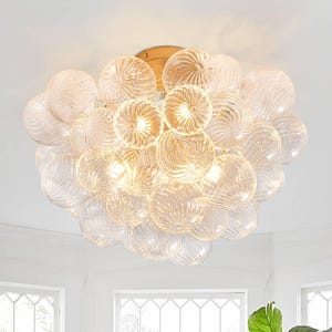 May include: A flush mount ceiling light fitting featuring a cluster of numerous clear, spherical glass globes with a ribbed, textured surface. The globes are arranged in a dense, rounded formation attached to a central gold-toned metal base.