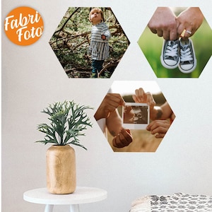 May include: Three hexagonal photo prints with white borders. The first print shows a young child standing in a forest. The second print shows a couple holding an ultrasound image. The third print shows a pair of hands holding a pair of black and white sneakers.