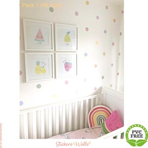 Repositionable polka dot wall stickers create instant, rental-friendly nursery decor around a baby's crib.