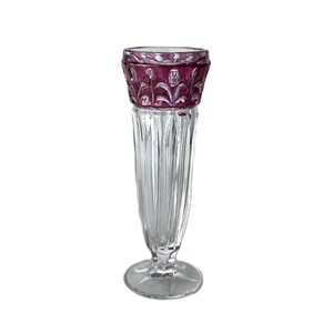 May include: A clear glass vase with a purple, cut-glass design at the top. The vase has a tall, slender body and a wide, round base.
