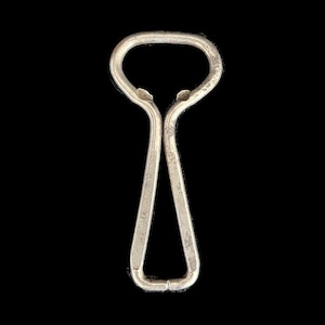 May include: A silver bottle opener with a simple design. The opener has a loop at the top and a pointed end.