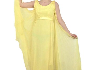 May include: A sleeveless yellow maxi dress with a flowing chiffon cape. The dress has a simple scoop neckline and a fitted bodice with a matching yellow sash.