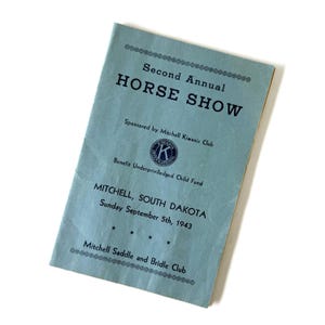 May include: A light blue paper program for the Second Annual Horse Show, sponsored by the Mitchell Kiwanis Club to benefit the Underprivileged Child Fund in Mitchell, South Dakota, dated Sunday, September 5th, 1943, by the Mitchell Saddle and Bridle Club.