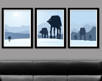 May include: Three framed prints of a snowy landscape with silhouettes of AT-AT walkers from the movie "The Empire Strikes Back".