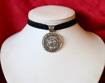 Gothic black velvet choker with sun star silver tone metal pendant