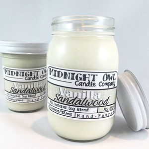 May include: Two glass jars with white lids containing vanilla sandalwood scented candles. The larger jar is labeled "Midnight Owl Candle Company Vanilla Sandalwood No. 047 14 ounces/473ml Hand-Poured". The smaller jar is labeled "Midnight Owl Candle Company Vanilla Sandalwood 7 ounces/236ml Hand-Poured".