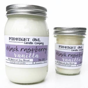 May include: Two glass jars with silver lids containing candles. The labels on the jars read "Midnight Owl Candle Company" and "Black Raspberry Vanilla". The larger jar is 16 ounces and the smaller jar is 8 ounces.