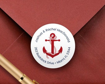 May include: A white round return address label with a red anchor and rope design. The text reads "Joshua & Rachel MacDonald, 263 Boatdock Drive, Miami, FL 33144".