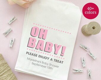 May include: White favor bag with pink polka dots and the text "Oh Baby! Please Enjoy a Treat Madeline's Baby Shower September 15th".