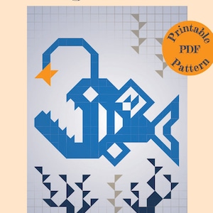 May include: A printable PDF pattern for a 40" x 54" cot quilt featuring a blue angler fish with a yellow lure. The pattern is set against a white grid background with gray and black triangle designs.