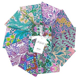 May include: A set of 10 fabric squares featuring a variety of floral and botanical patterns in shades of pink, purple, green, and blue. The fabric squares are labeled "Free Spirit" and are perfect for quilting, crafting, and other sewing projects.
