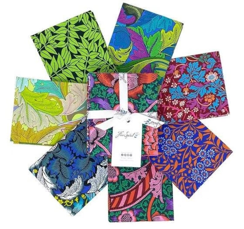 May include: A set of eight fabric squares featuring various floral patterns in shades of green, blue, red, and purple. The fabric squares are arranged in a circle with a white tag in the center that reads "Fine Spiral".
