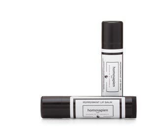 May include: Two black tubes of peppermint lip balm with white labels that read "Peppermint Lip Balm" and "homosapien Organics & Herbals".