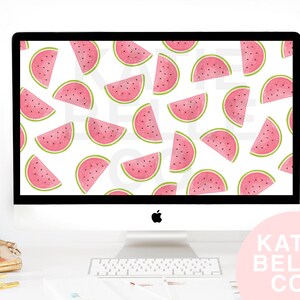 May include: A computer monitor displays a repeating pattern of pink watermelon slices with green rinds on a white background. The monitor is on a white desk with office supplies and a pink floral arrangement. The text "KATIE BELLE CO." is in a pink circle.