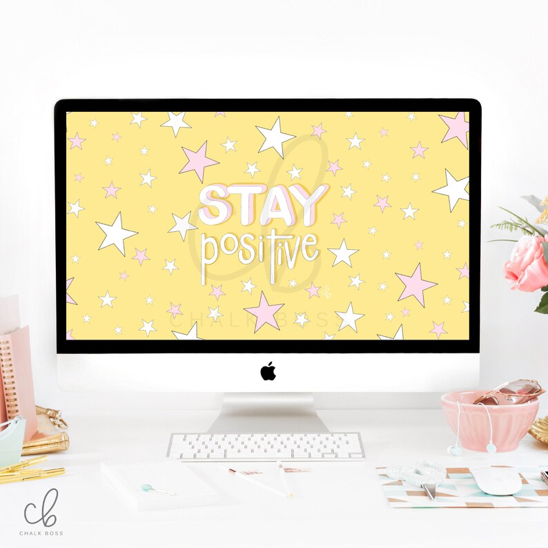 May include: A yellow desktop background with white and pink stars and the text "STAY positive" in a pink and white outline. The background is displayed on a white iMac computer.