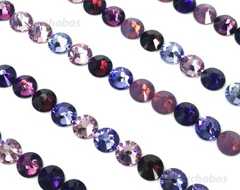 May include: Four rows of round, faceted glass rhinestones in shades of purple, pink, and red. The rhinestones are arranged in a repeating pattern.