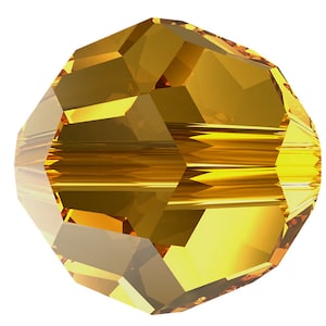 May include: A faceted, amber-colored glass bead with a round shape and a smooth, shiny surface.