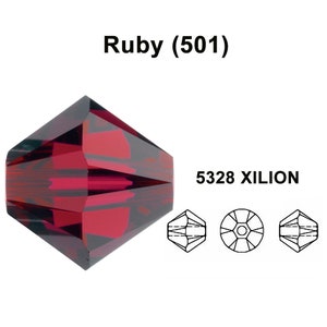 May include: A ruby red crystal bead with a faceted design. The bead is a 5328 XILION bead, which is a type of bead that is known for its brilliance and sparkle.