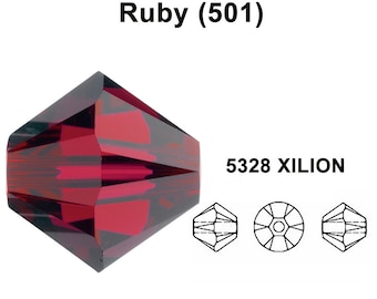 May include: A ruby red crystal bead with a faceted design. The bead is a 5328 XILION bead, which is a type of bead that is known for its brilliance and sparkle.