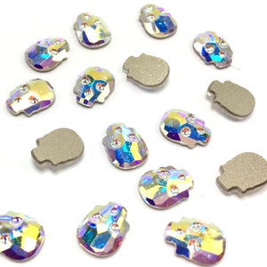 May include: Assortment of iridescent skull-shaped rhinestones, some with a flat back, perfect for crafting and decorating.