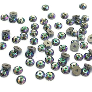 May include: A scattering of iridescent black rhinestones with a silver backing. The rhinestones are round and have a faceted design.