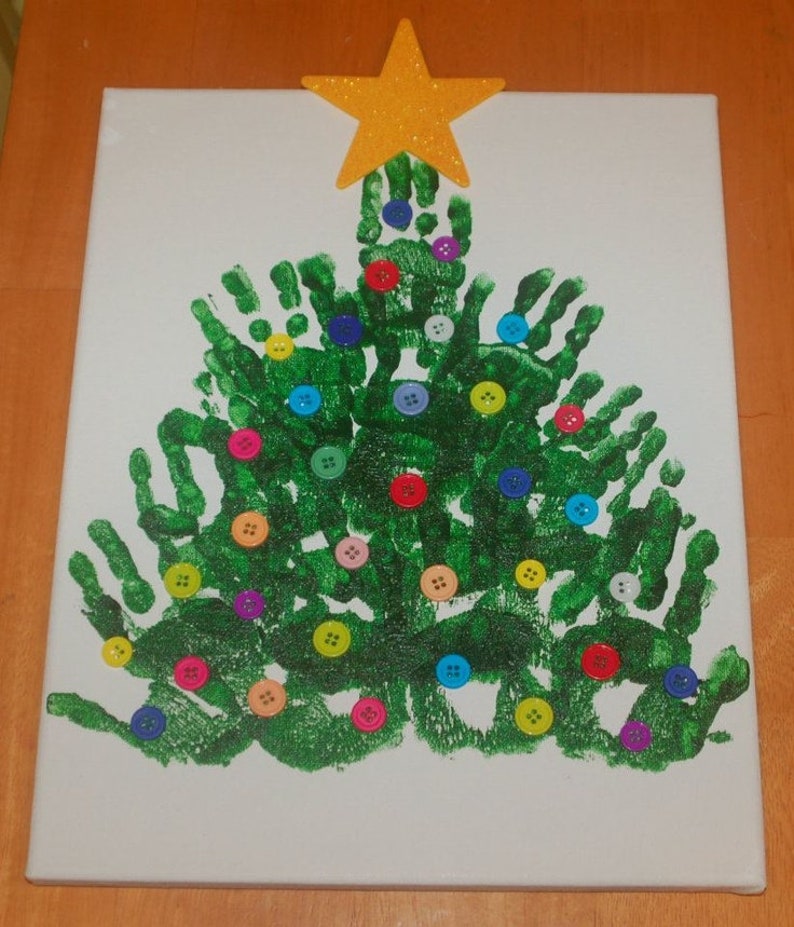 May include: A green handprint Christmas tree with colorful buttons as ornaments and a gold glitter star on top.