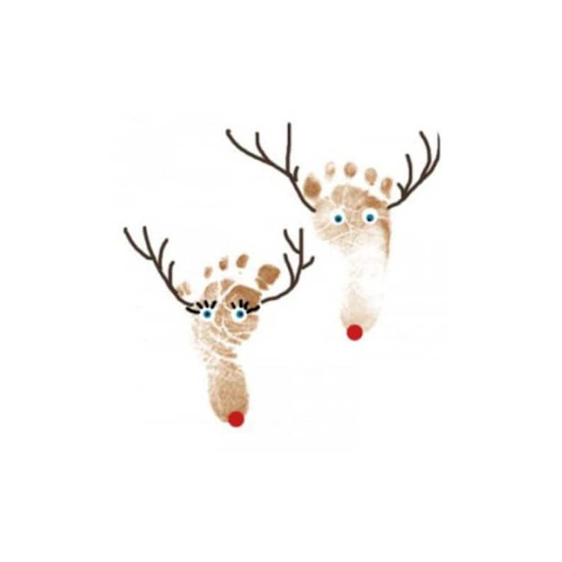 May include: Two brown reindeer made from baby footprints with black antlers and blue eyes. The reindeer have red noses.