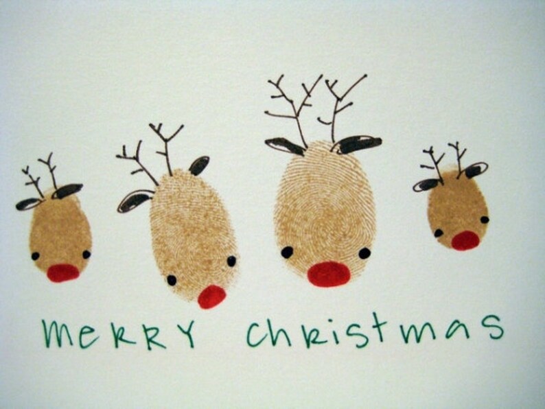 May include: A white card with four brown reindeer drawn with fingerprints. The reindeer have black eyes and red noses. The card says "merry christmas" in green letters.