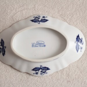 May include: White oval ceramic dish with blue floral designs and the text "V. Madeleines Blue China" on the bottom.