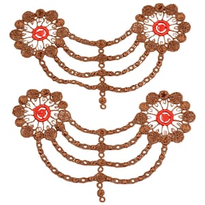 May include: Two brown crocheted floral embellishments with red centers, each attached to a chain of brown beads. The chains are layered and connected to form a decorative piece.